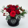 Red winter bouquet in a black box, flower delivery Vilnius